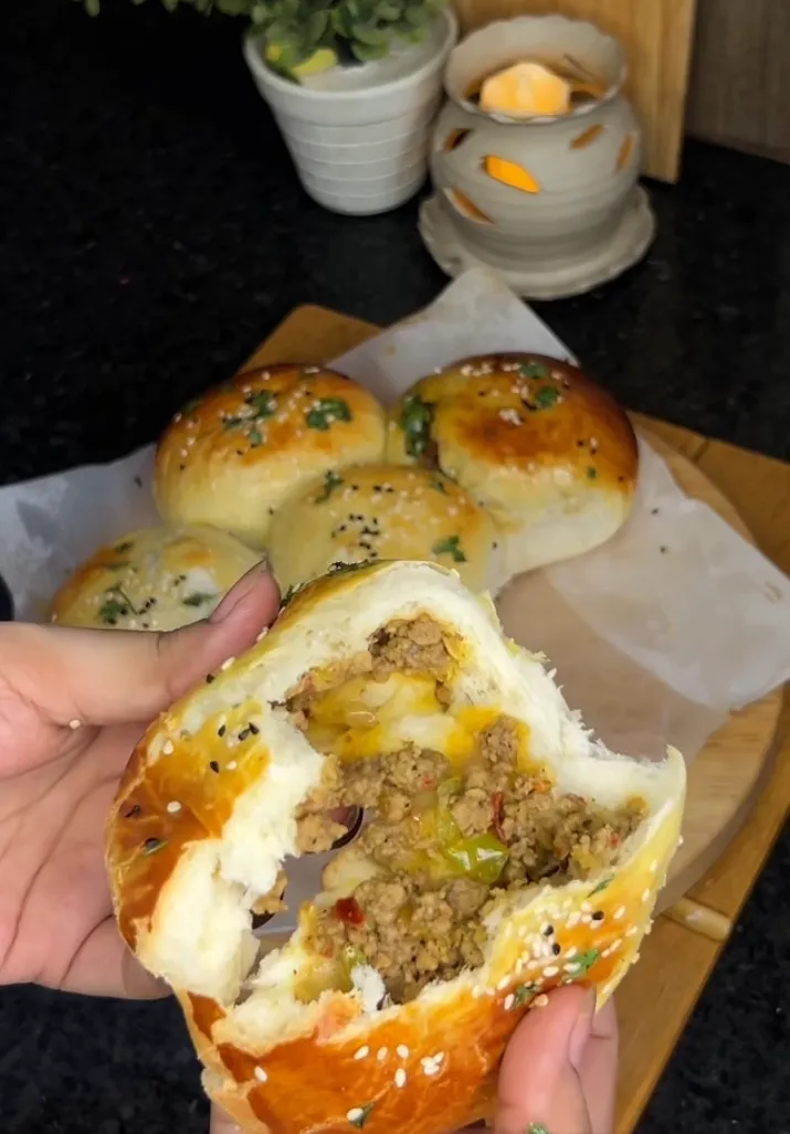 Soft golden beef stuffed buns torn open to show the spiced ground beef filling