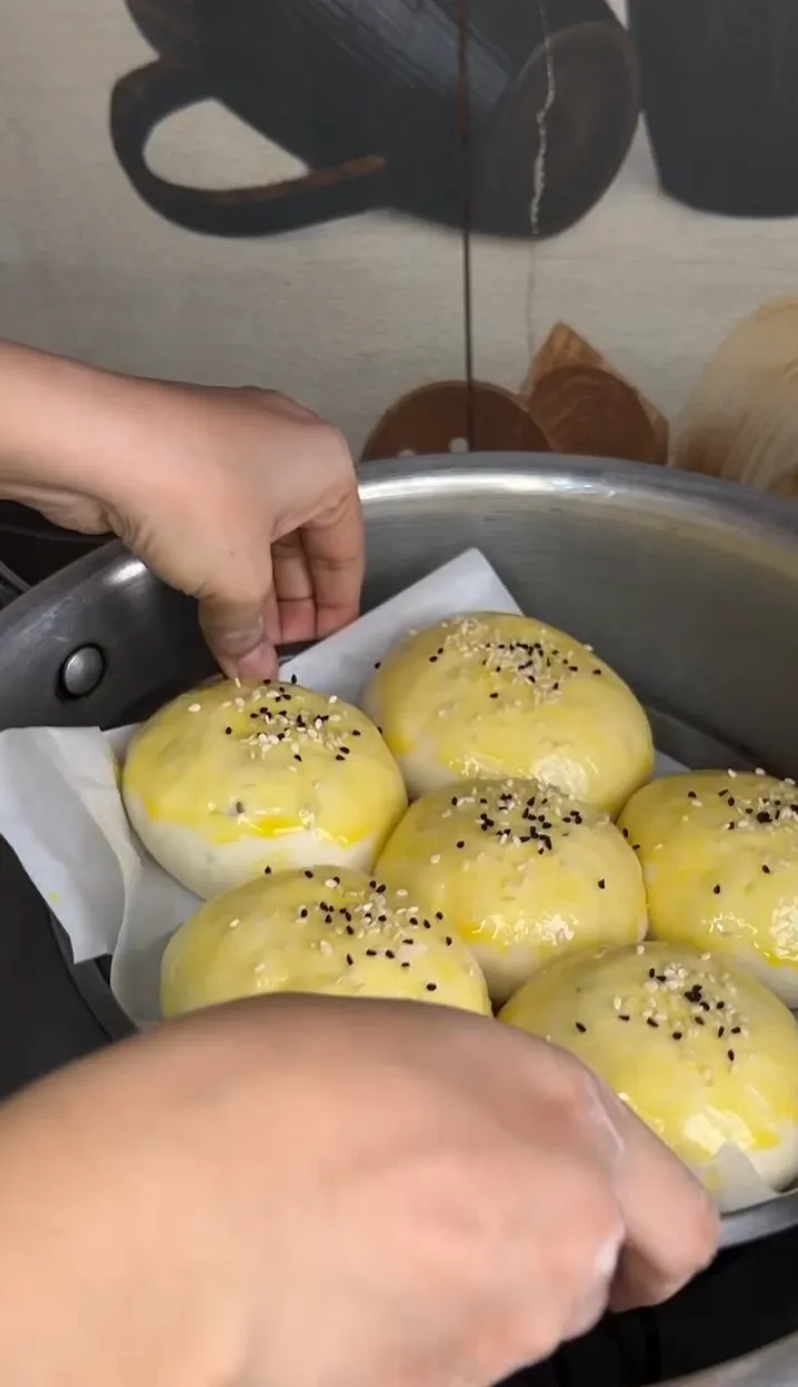 Shaped buns brushed with egg wash and sprinkled with sesame and nigella seeds