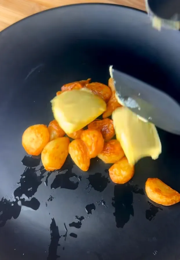 Roasted garlic and butter on a plate, ready to be mashed