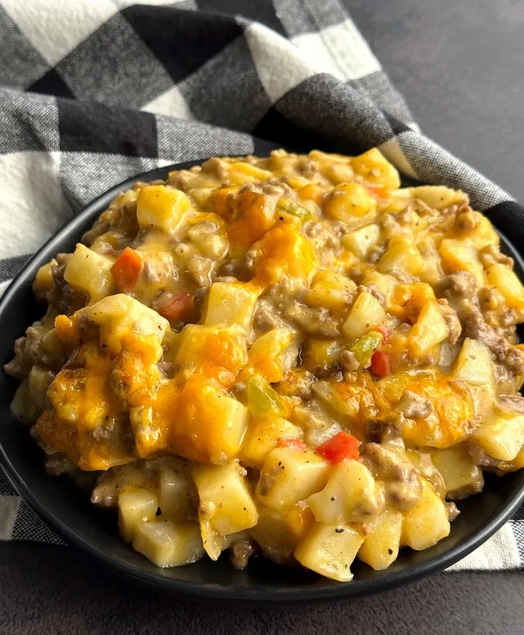 Close-up of cheesy ground beef and potato casserole in a bowl