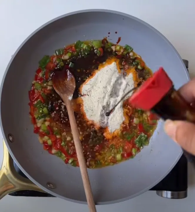 Soy sauce, chili garlic sauce and ramen seasoning added to the fried aromatics