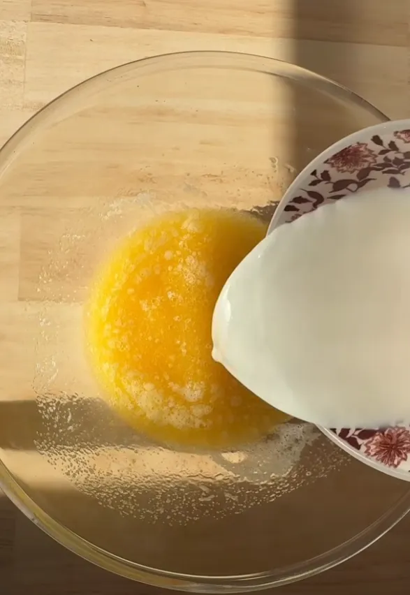Milk being added to the egg mixture