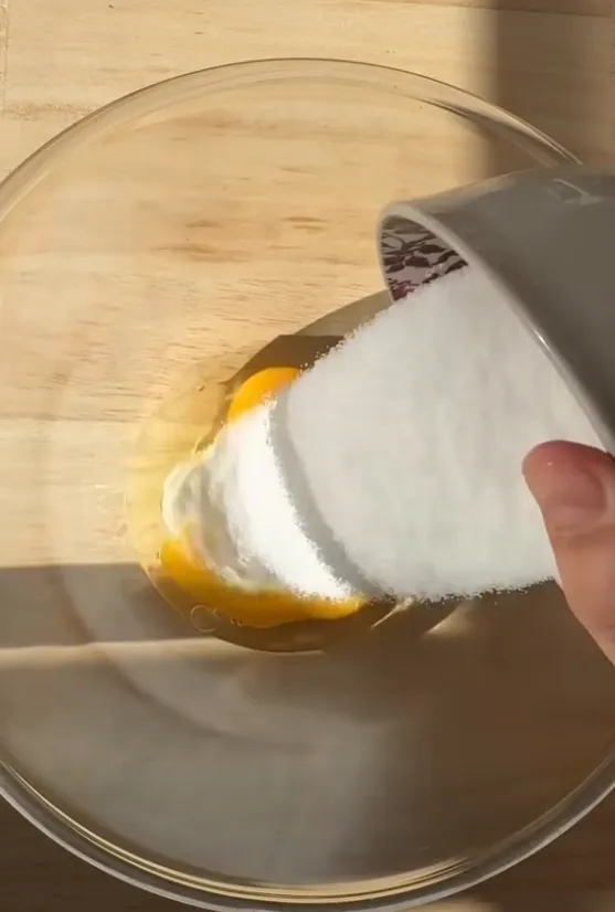 Sugar being added to the eggs
