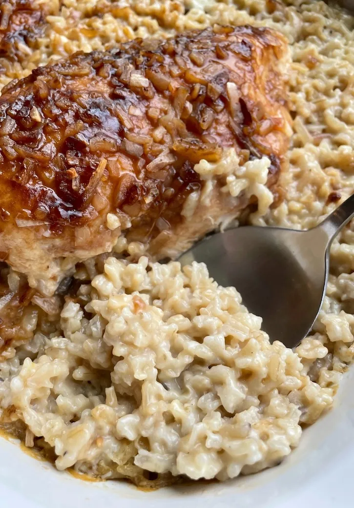Golden caramelized French onion chicken on creamy baked rice, fresh from the oven