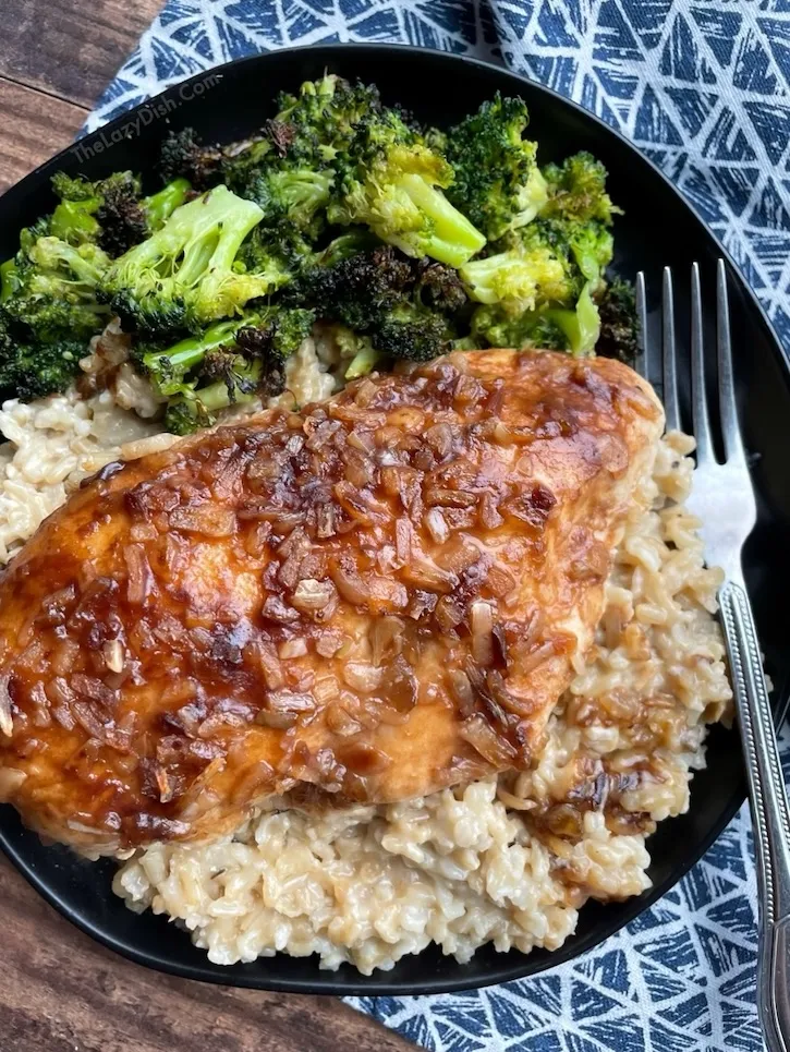 French onion chicken and rice served on a plate with roasted broccoli