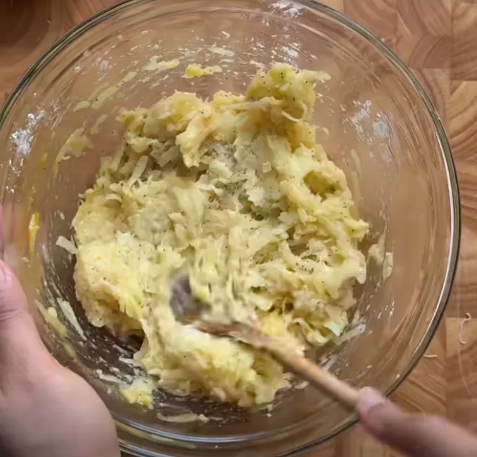 The hashbrown mixture mixed into a sticky potato batter, and a shaped oval patty