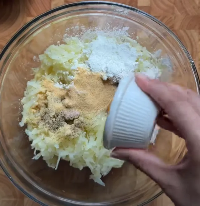 Garlic powder, flour, salt and pepper added to the grated potato