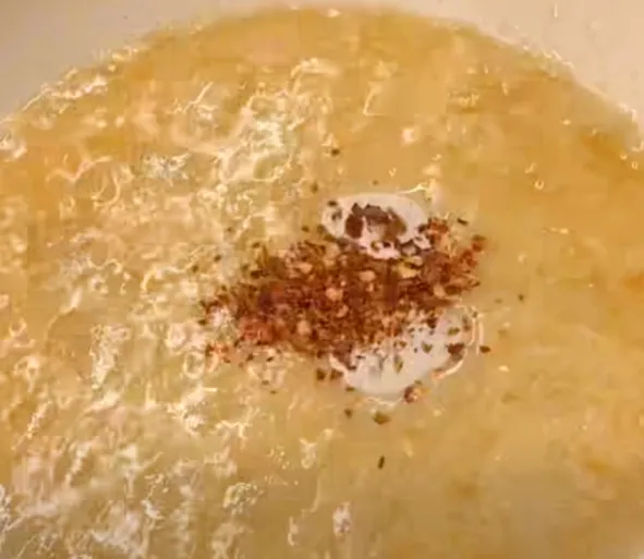 Chilli flakes sizzling in the hot garlic butter